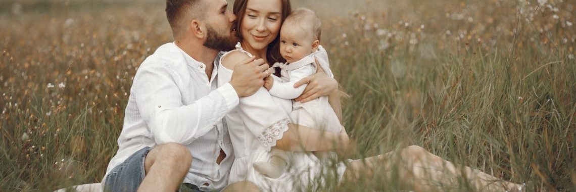 Happy family enjoying quality time in a serene meadow setting.